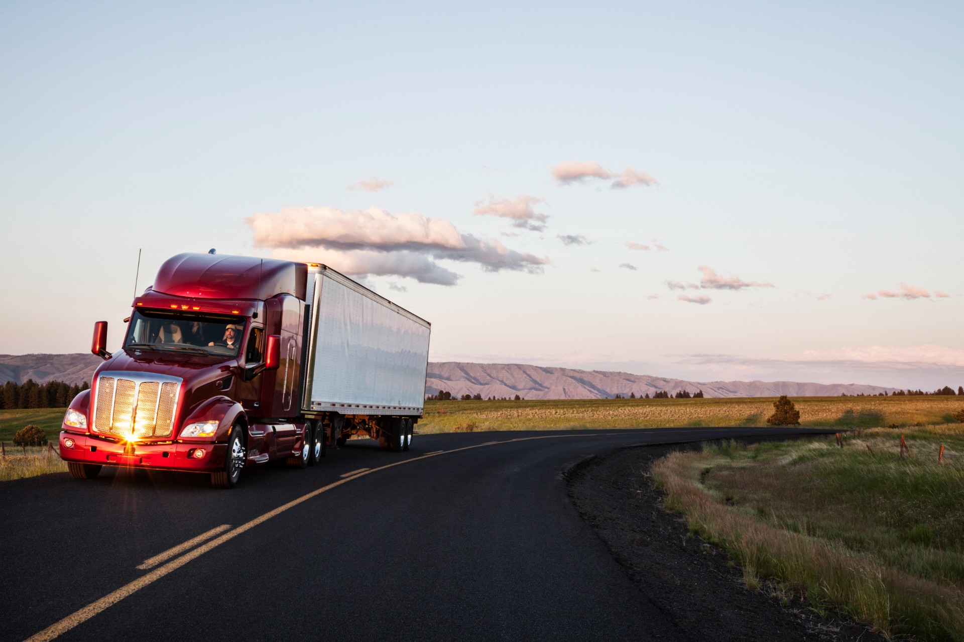 truck-on-a-highway-through-the-grasslands-area-of-2023-11-27-05-14-47-utc.jpg