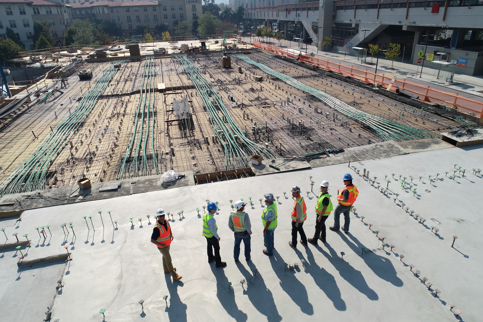 Construction workers reviewing plans together on site