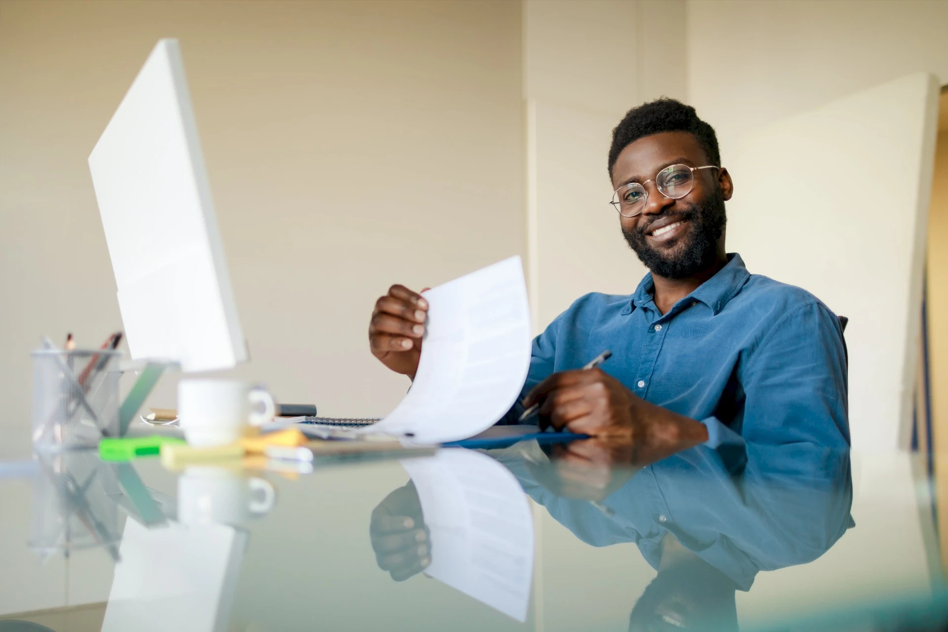 A hiring manager reviewing a resume at their desk